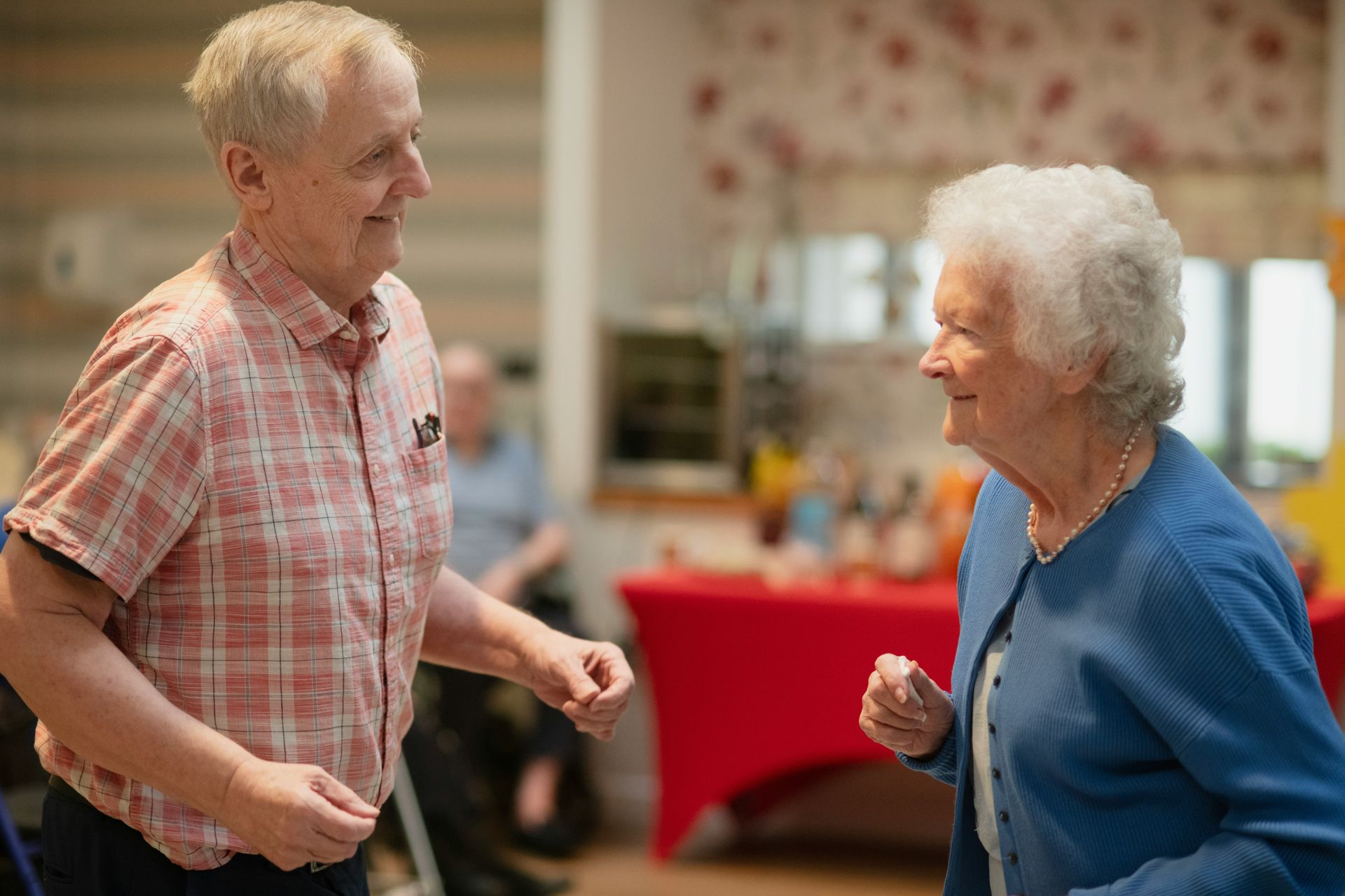 Elderly couple dancing and smiling at each other